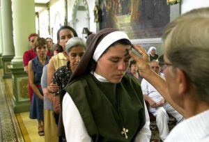 Nun receives blessing in church on Ash Wednesday